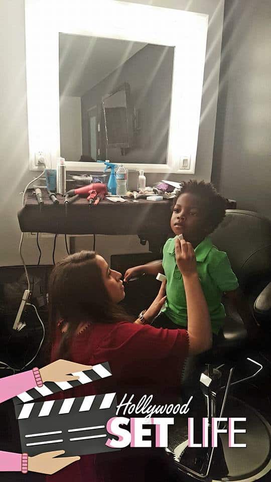 child getting hair and makeup done for modeling