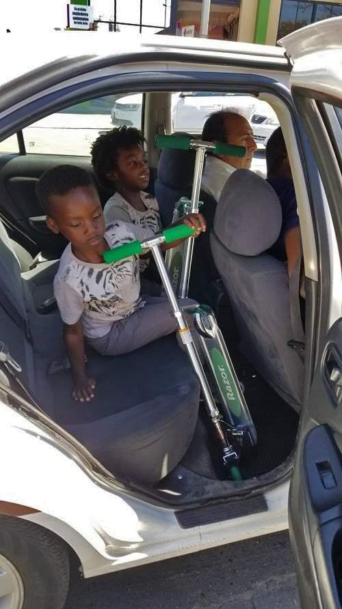 Two kids in teh back seat of an Uber in Tijuana