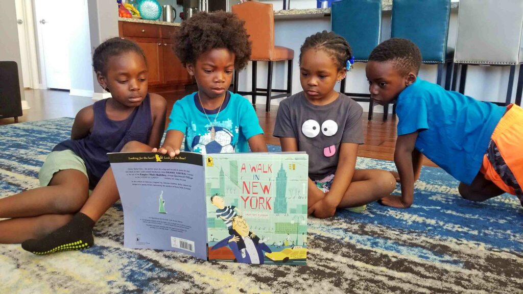 black kids reading a book