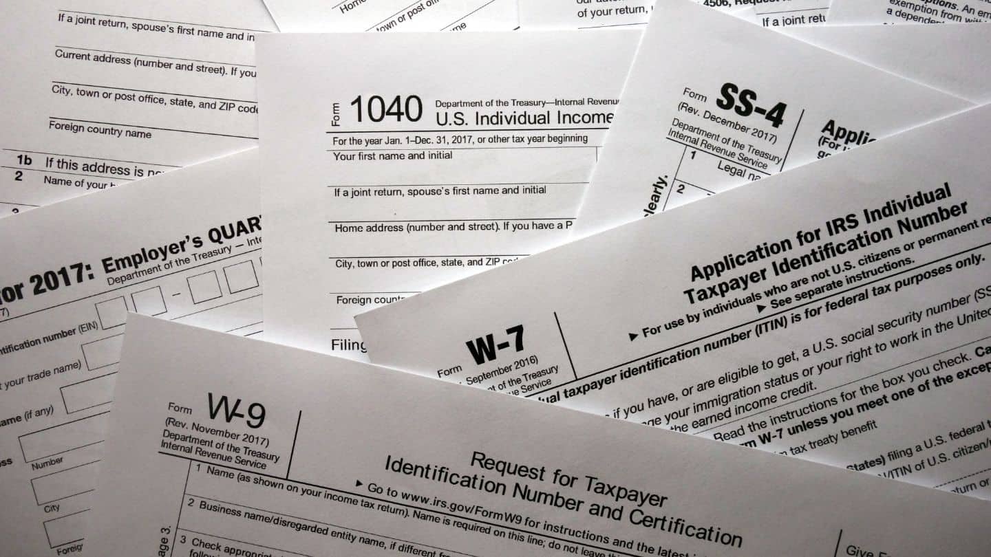 Tax forms representing the difference in Roth IRA vs Traditional IRA tax requirements for a child