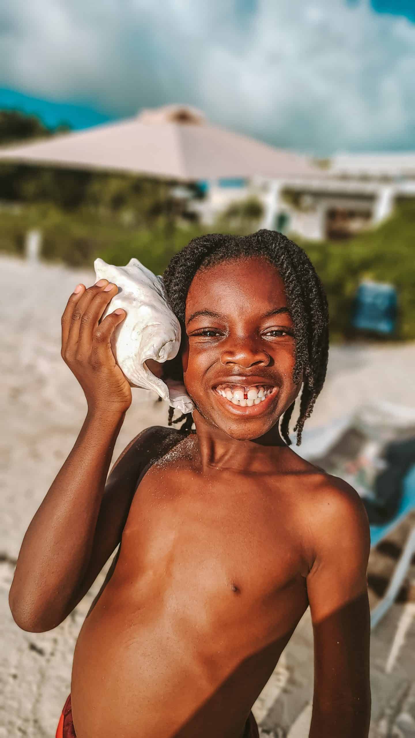 Kid listening to seashell