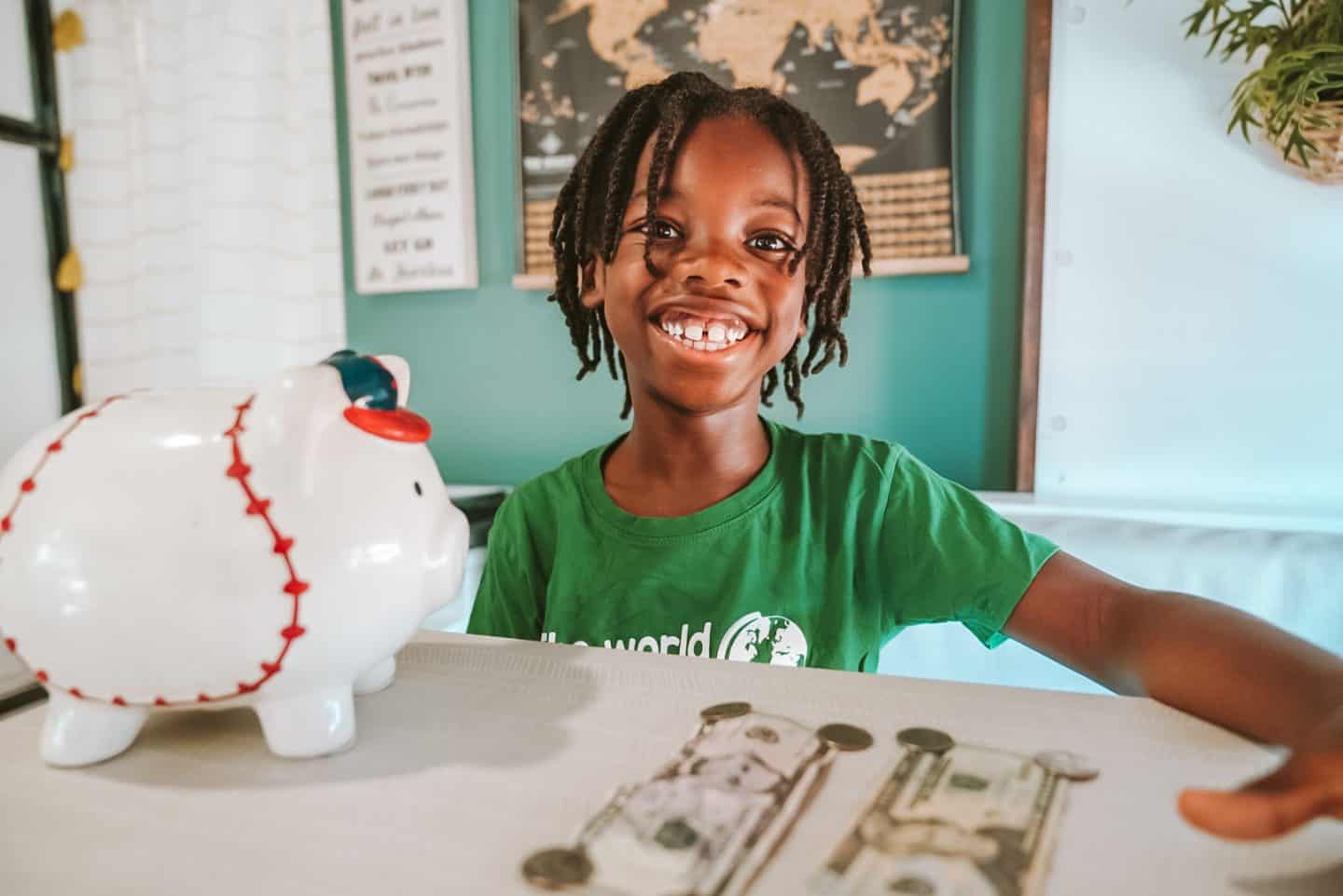 Black child with piggy bank