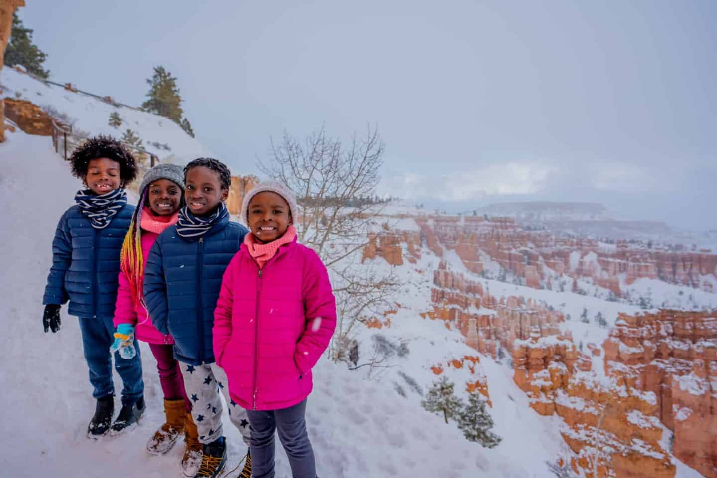 Children standing in front of a grand view at Bryce Canyon National Park.