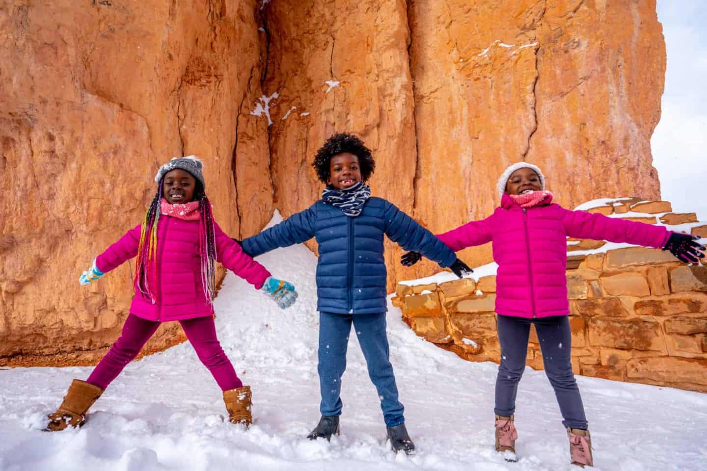 Three children posing at Bryce Canyon National Park .