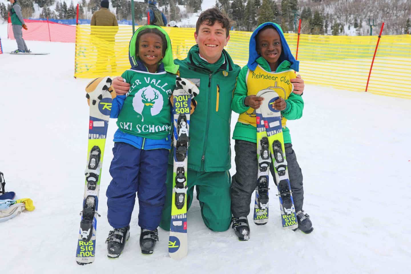 black kids receive ski lesson from instructor
