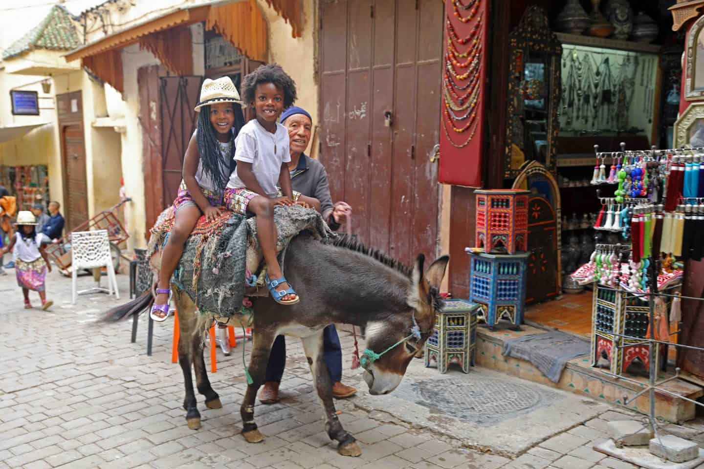 kids riding a donkey in Morocco