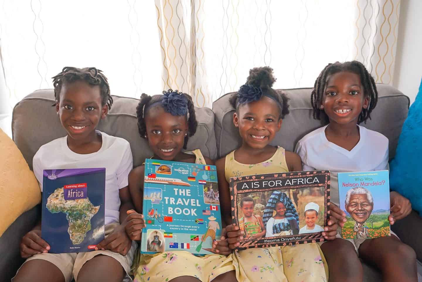 Black kids holding educational books