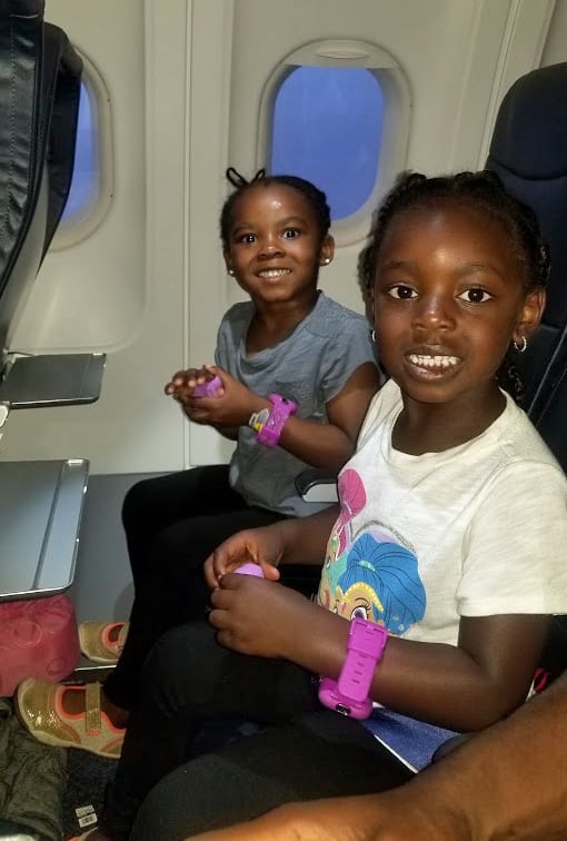 Two girls playing with playdoh on a Spirit Airlines Flight - how to avoid extra fees when flying spirit airlines 8