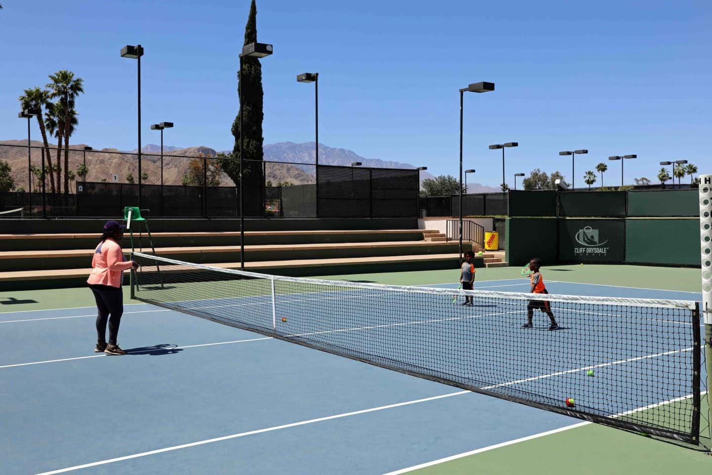 family playing tennis in Palm Springs - how to vacation in palm springs with kids
