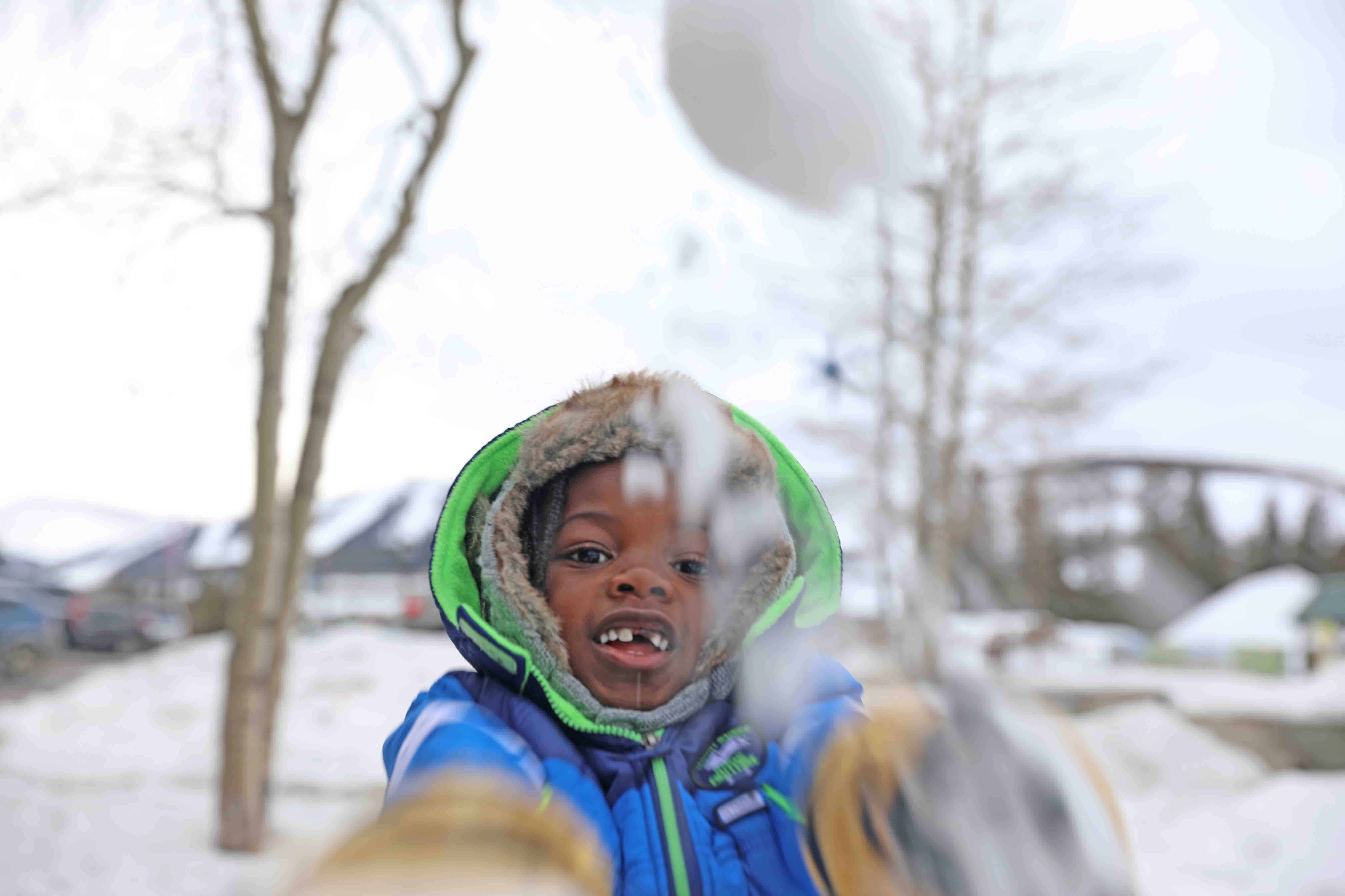 Black Family Travel snow ball fight