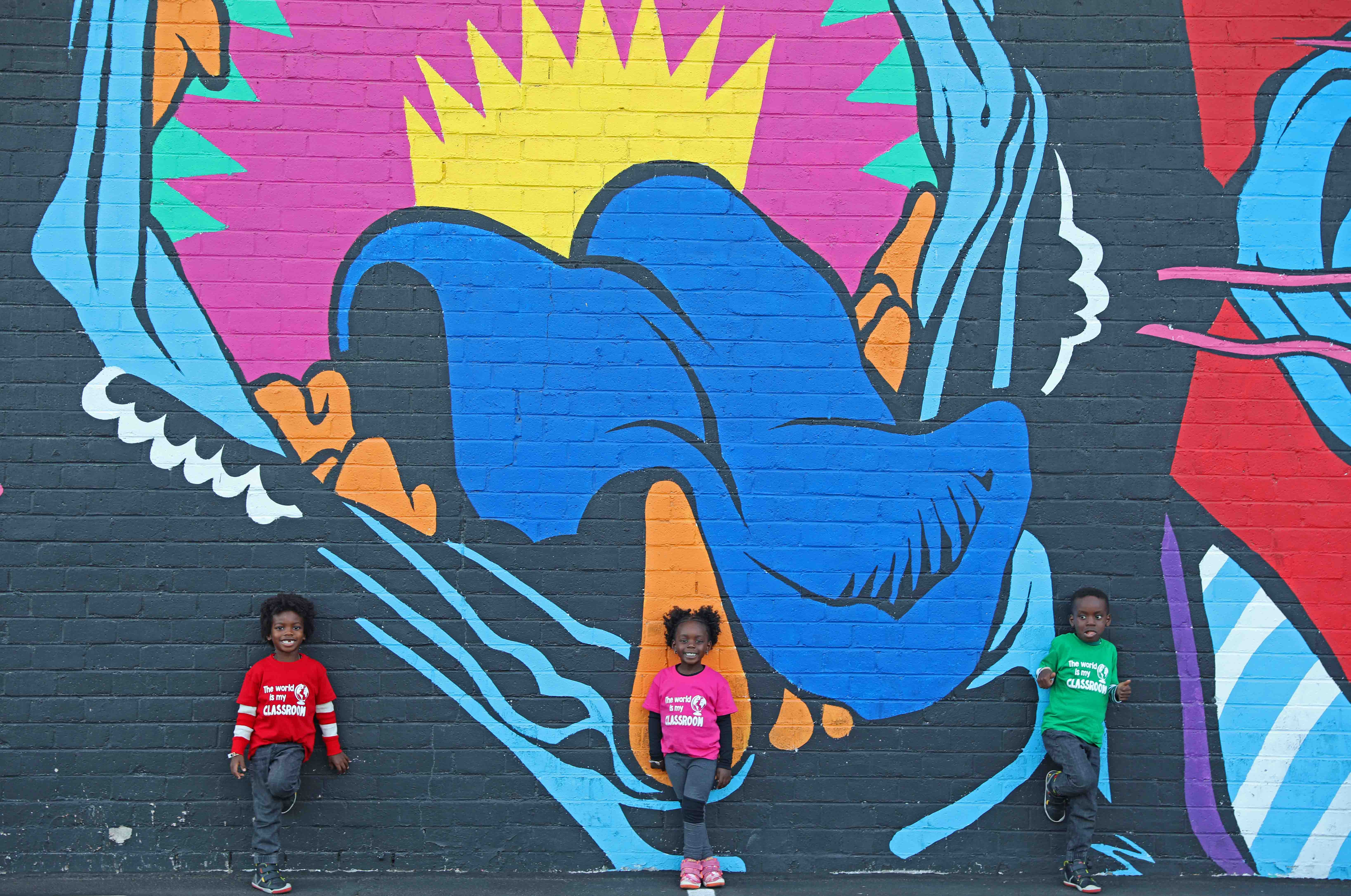 black kids posing in mural